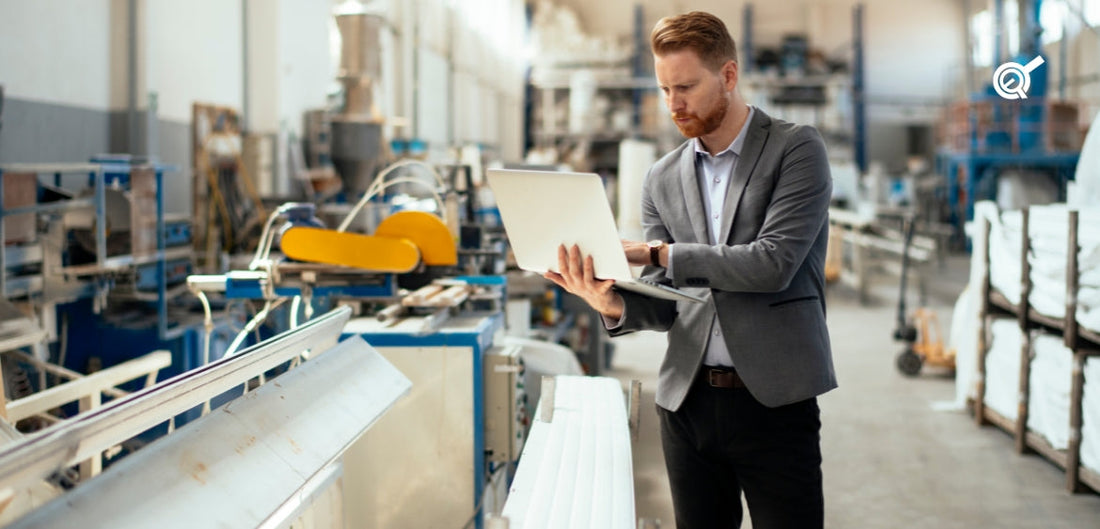 a man with a laptop at the factory