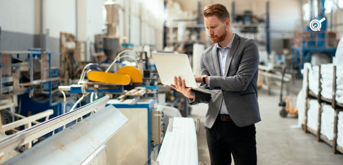 a man with a laptop at the factory