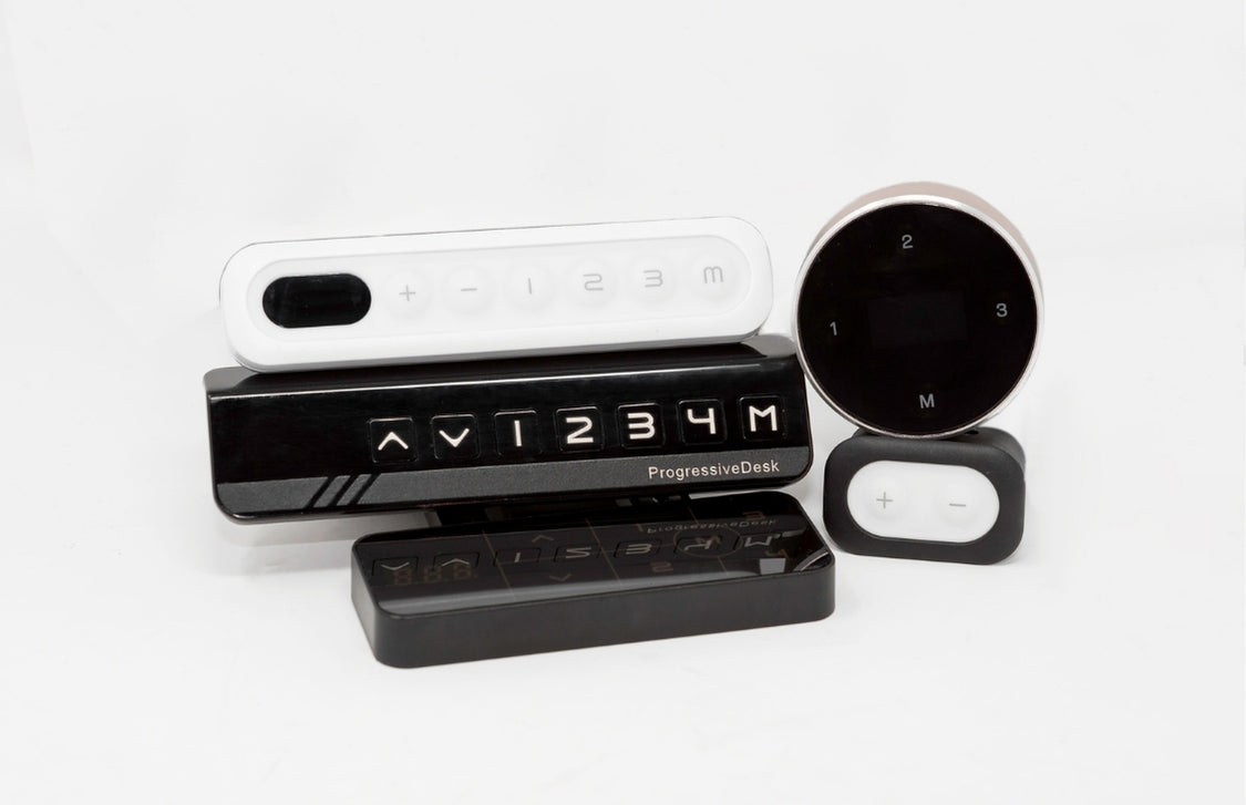 Assorted desk control remotes with memory settings and adjustment buttons  
